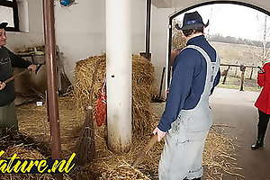 Hairy horse tamer double penetrated in horse stable for the brush tricky stage