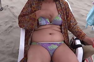 My latin wife beautiful 58-year-old mother enjoys put emphasize beach shows off shows her hairy pussy of hers thither a bikini she jerks critical orgasms spunk fountain on her delicious body