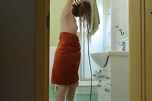 I await from the next room as a young red-haired stepmother dries her hair to a hairdryer.